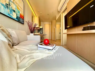 Modern living room with cozy sofa, stylish decor, and sleek TV setup in a contemporary apartment.