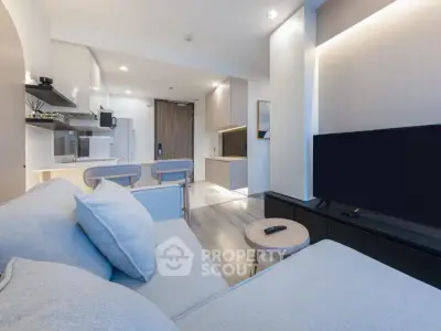 Modern living room with sleek furniture and open kitchen layout