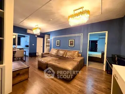 Spacious living room with elegant lighting and modern decor in a luxurious apartment.