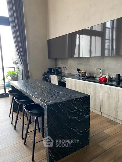 Luxurious modern kitchen with sleek island and high-end appliances, perfect for gourmet cooking.