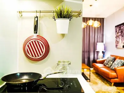 Modern kitchen with induction cooktop and stylish living room view