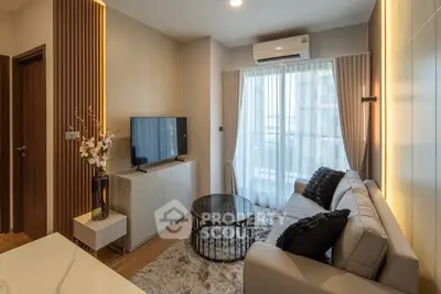 Modern living room with stylish decor, cozy sofa, and large window for natural light.