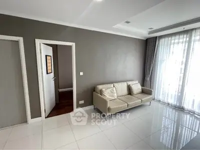 Spacious living room with modern sofa and large windows for natural light