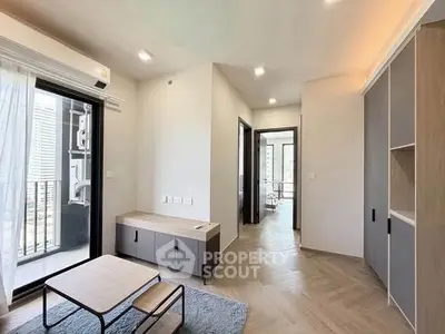 Modern living room with balcony access and stylish furniture in a contemporary apartment.