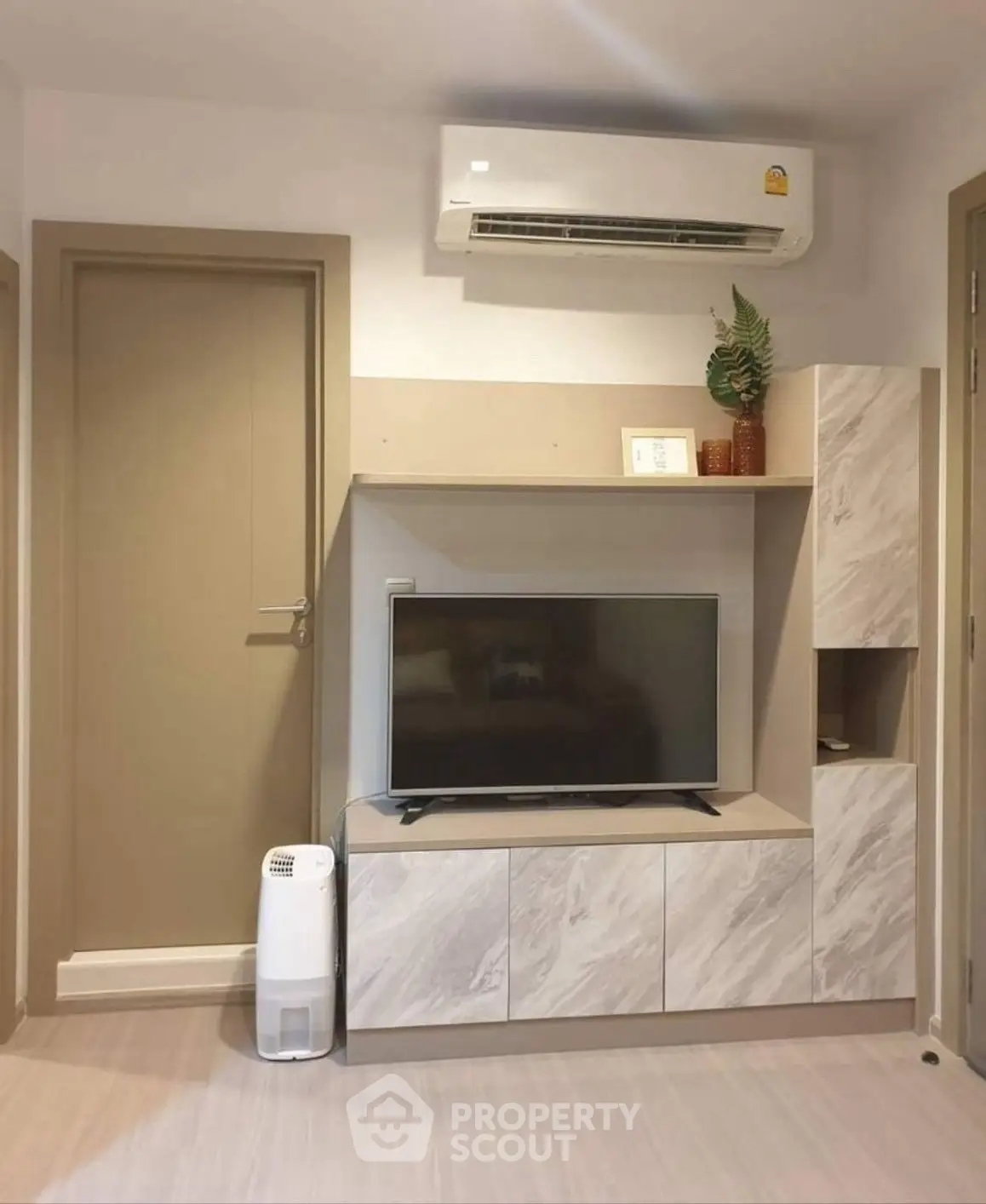 Modern living room with sleek TV unit and air conditioning
