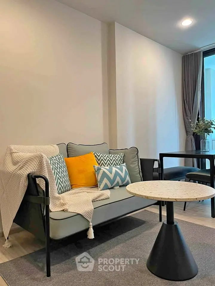 Modern living room with stylish sofa and chic decor in a cozy apartment setting.