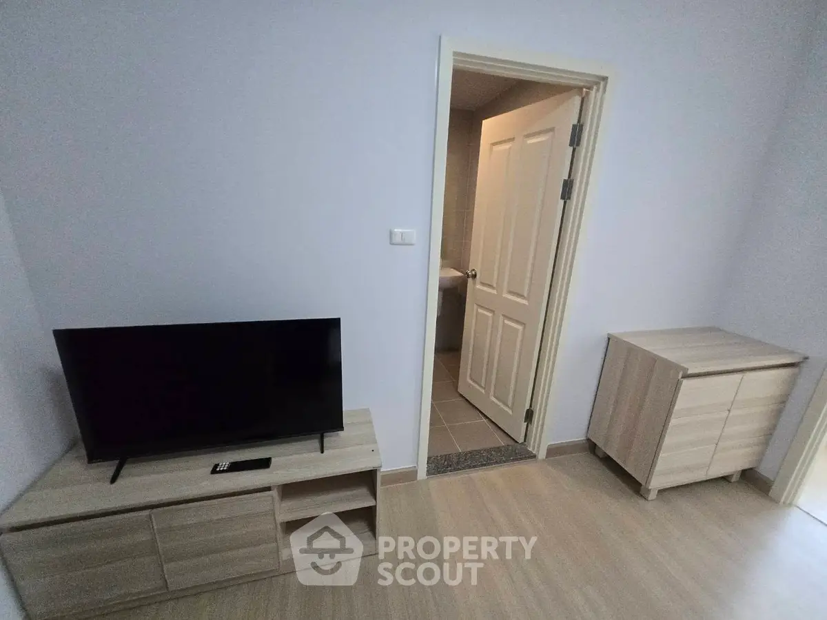 Modern minimalist living room with TV and wooden furniture