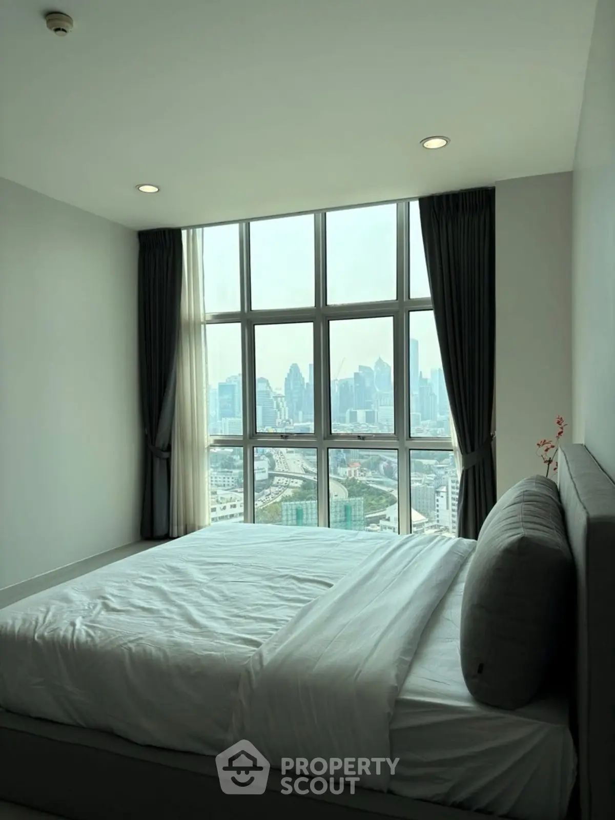 Modern bedroom with stunning city view and large windows