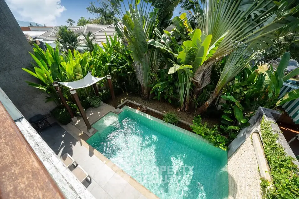 Luxurious private pool surrounded by lush greenery in a tropical paradise setting.