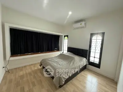 Spacious bedroom with modern design and large window view