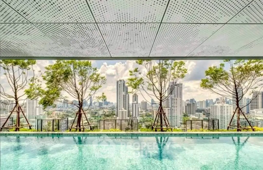 Stunning rooftop pool with panoramic city skyline view and lush greenery.