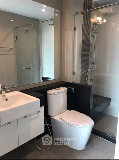 Modern bathroom with sleek fixtures and a glass-enclosed shower