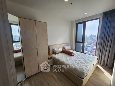 Modern bedroom with city view, featuring a cozy bed and stylish wardrobe.
