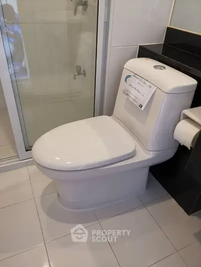 Modern bathroom with sleek toilet and glass shower enclosure