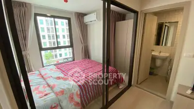 Cozy bedroom with ensuite bathroom and large window in modern apartment