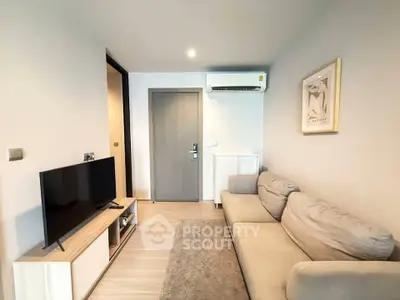 Modern living room with cozy sofa, TV, and air conditioning in a stylish apartment.