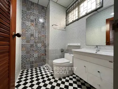 Stylish bathroom with patterned tiles and modern fixtures