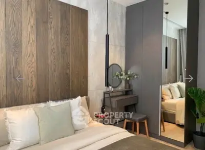 Modern bedroom with stylish decor and mirrored wardrobe