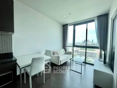 Modern living room with city view, featuring sleek furniture and large windows for natural light.