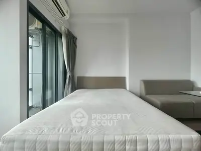 Modern bedroom with minimalist design and large window for natural light