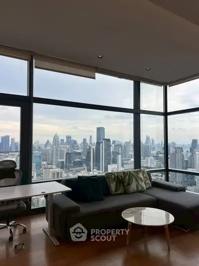 Luxurious modern living room with panoramic city skyline view, featuring stylish furniture and floor-to-ceiling windows.