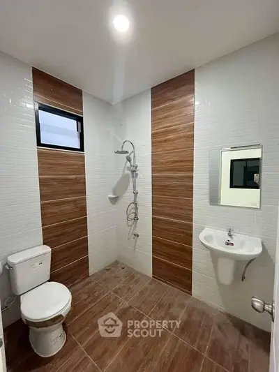 Modern bathroom with sleek design and wooden tile accents