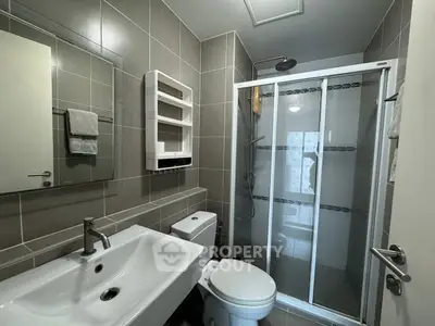 Modern bathroom with sleek fixtures and glass shower enclosure