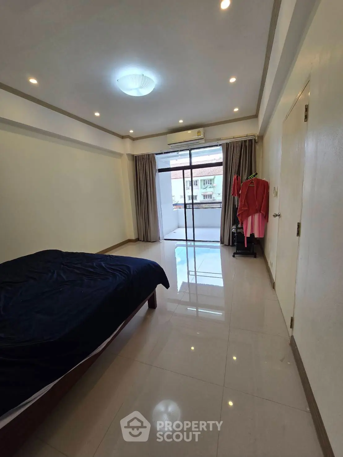 Spacious bedroom with balcony access and natural light