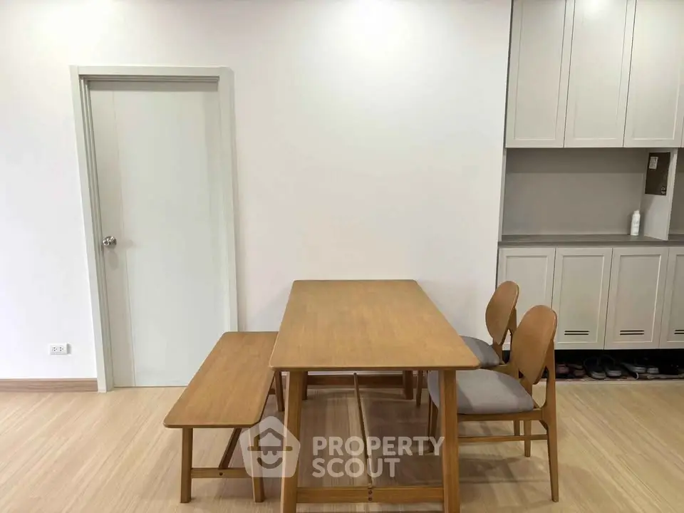 Modern dining area with wooden table and chairs, minimalist design, perfect for cozy family meals.