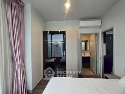 Modern bedroom with city view, air conditioning, and ensuite bathroom.