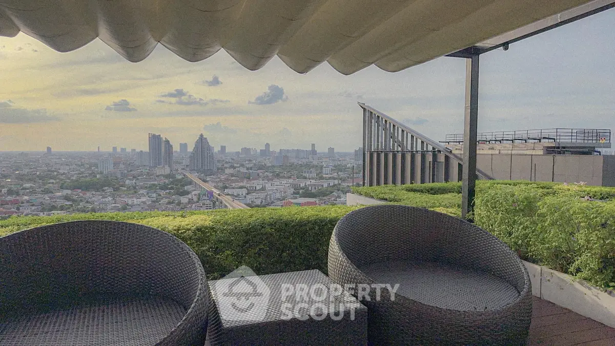 Stunning rooftop view with modern seating overlooking city skyline at sunset.