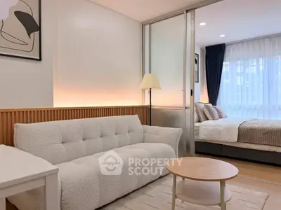 Modern studio apartment with cozy living area and stylish bedroom