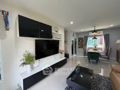 Modern living room with sleek black entertainment unit and cozy dining area, perfect for stylish urban living.