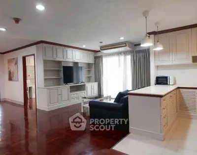 Spacious living room with modern kitchen and elegant wooden flooring
