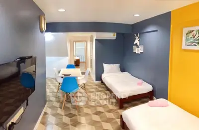 Charming modern living space with twin beds and vibrant decor