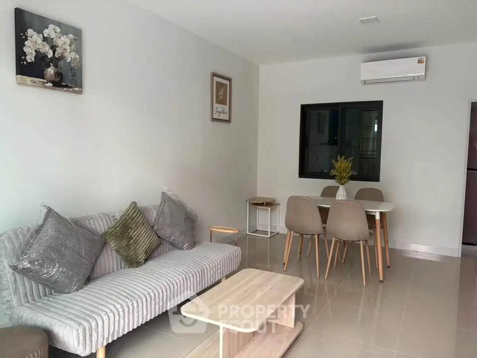 Modern living room with stylish furniture and air conditioning in a contemporary apartment.