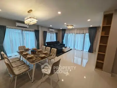 Luxurious open-plan living room with elegant dining area and modern decor