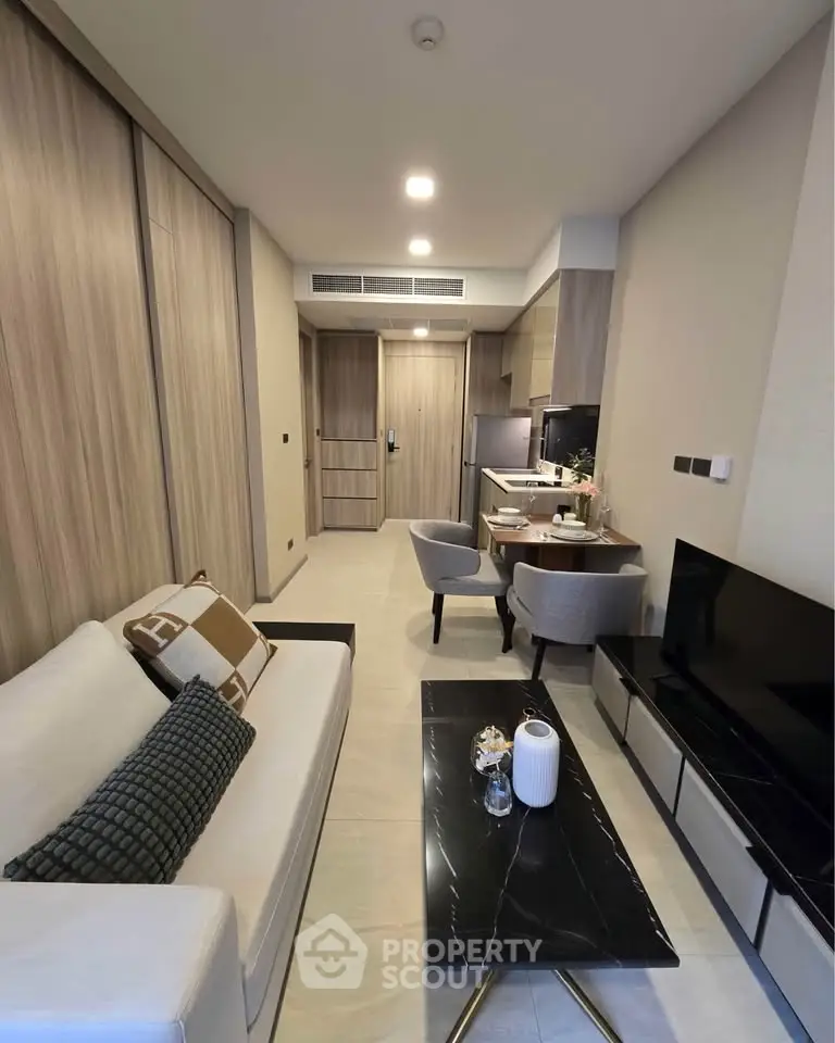 Modern living room with stylish furniture and open kitchen layout