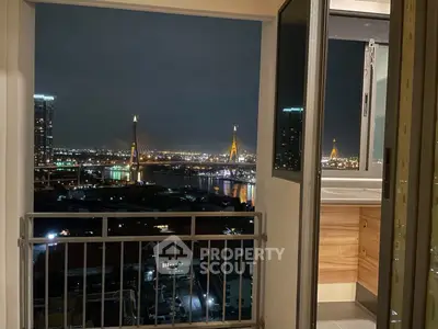 Stunning night view from a high-rise balcony overlooking a cityscape with iconic bridges.