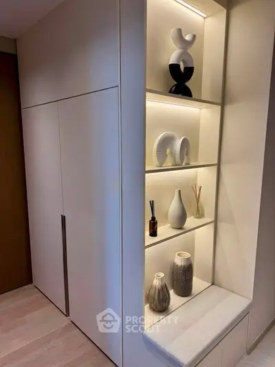Modern interior with stylish built-in shelving and decorative vases in a cozy corner.