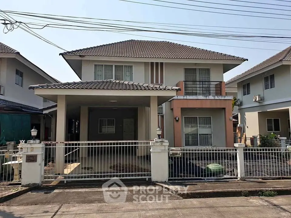 Charming two-story house with spacious driveway and modern design in a suburban neighborhood.