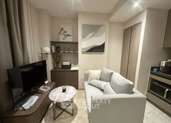 Cozy modern living room with stylish decor and compact kitchen area.