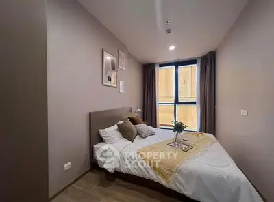 Cozy modern bedroom with stylish decor and large window