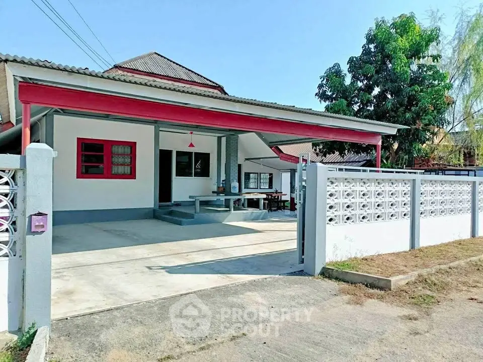 Charming single-story house with spacious driveway and modern exterior design in a serene neighborhood.