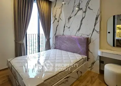 Luxurious bedroom with marble accent wall and elegant decor