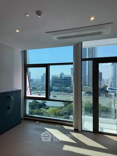 Stunning high-rise apartment with floor-to-ceiling windows offering breathtaking city and river views.