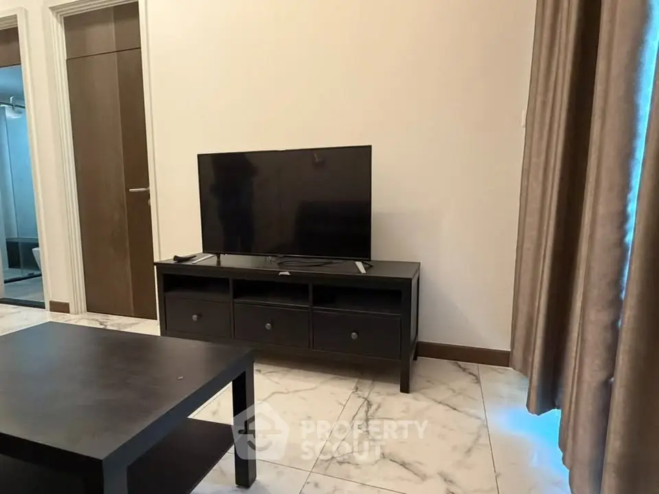 Modern living room with sleek TV stand and marble flooring, perfect for cozy entertainment nights.