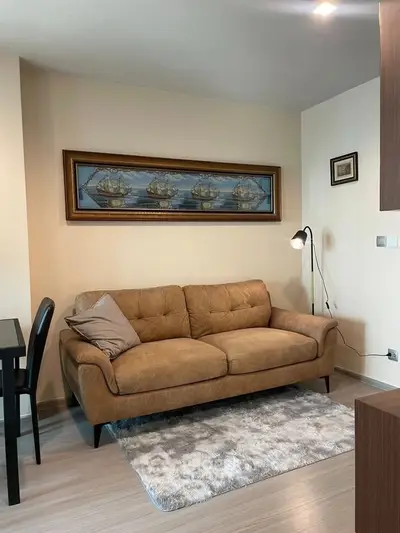 Cozy living room with stylish brown sofa and elegant wall art, perfect for relaxation.