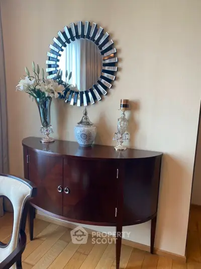 Elegant interior with stylish console table and decorative mirror in a modern living room setting.