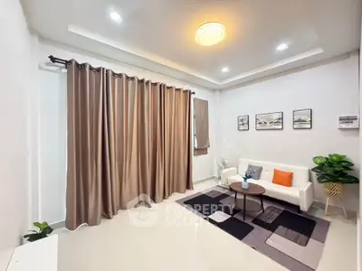 Modern living room with elegant decor, cozy seating, and stylish lighting.